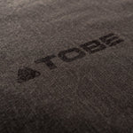 Printed TOBE Logo on base layer pant leg.